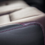 Modern luxury car  black and red leather interior. Part of  leather car seat details.